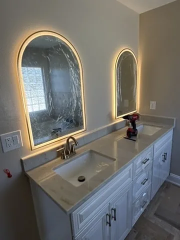 A double vanity and new lighting — typical of a mid-range primary bath.