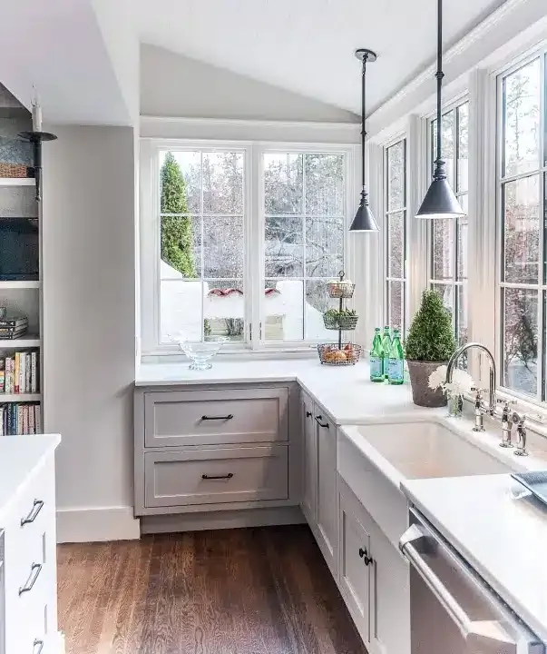 Farmhouse sink kitchen under a bright window